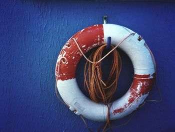 Life belt and ropes hanging from wall