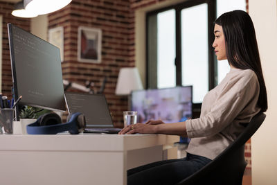 Young woman using laptop at office