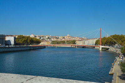 Bridge over river with buildings in background