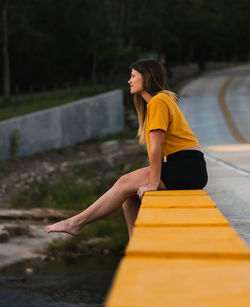 Side view of woman sitting on seat