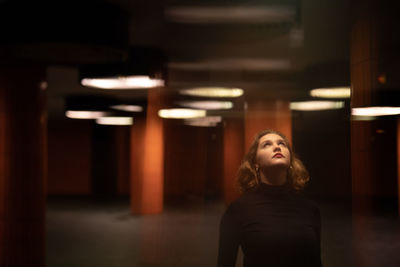 Portrait of young woman looking up