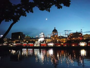 Reflection of illuminated buildings in city at night