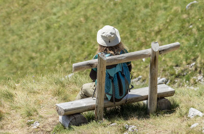 Man sitting on seat in field