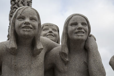 Low angle view of female statue against sky