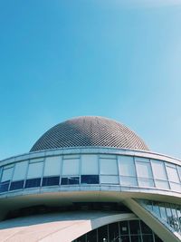 Low angle view of modern building against clear blue sky