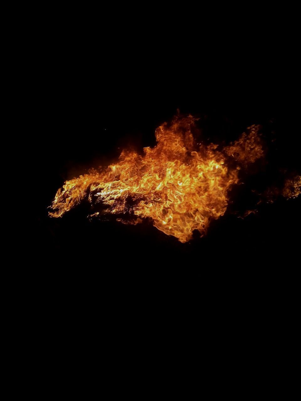 CLOSE-UP OF BONFIRE AGAINST BLACK SKY