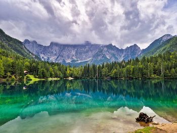 Scenic view of lake and mountains against sky