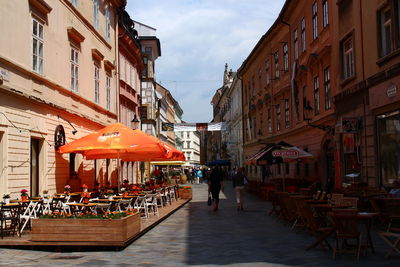 Sidewalk cafe amidst buildings in city