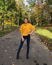 Portrait of teenage girl standing on footpath