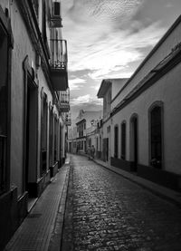 Empty alley amidst buildings in city