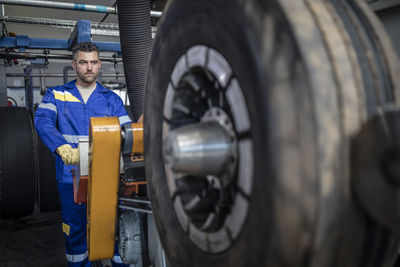 Repairman tuning tire on machine