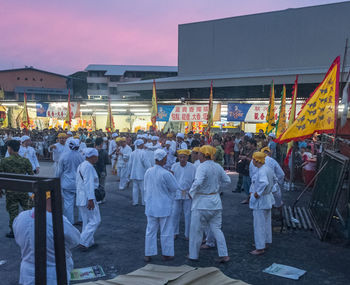 People walking in front of street at dusk