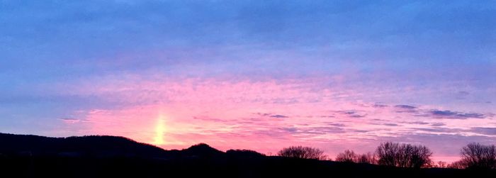 Scenic view of silhouette landscape against sky at sunset