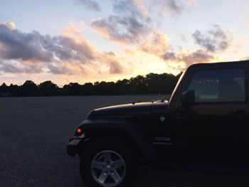 Cars on road at sunset