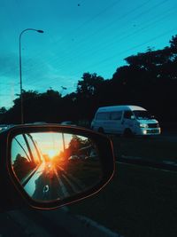 Car on road against sky during sunset
