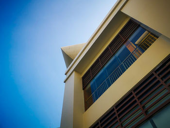 Low angle view of modern building against clear blue sky