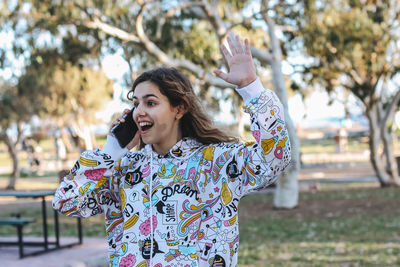 Portrait of smiling young woman standing outdoors