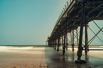 Pier over sea against clear sky