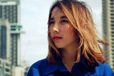 Close-up of woman with tousled hair