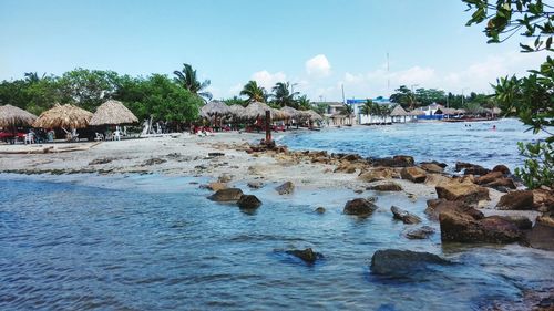 Scenic view of beach against blue sky