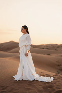 Young woman standing at desert 