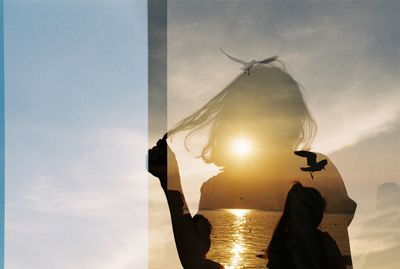 Digital composite image of sky during day and people at beach during dusk