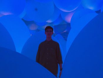 Shadow of man standing against blue wall