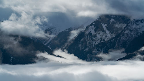 Low angle view of snowcapped mountains against sky