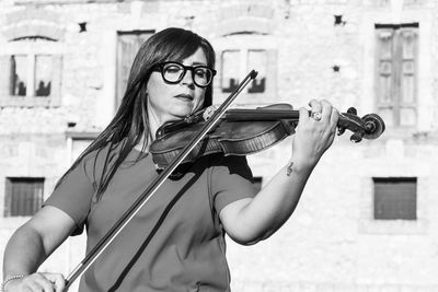 Woman playing violin outdoors