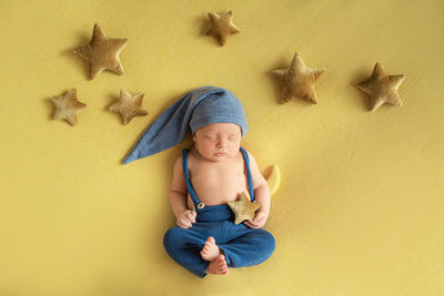 High angle view of woman standing against yellow background