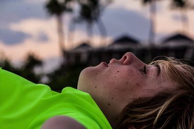 Close-up of boy lying outdoors