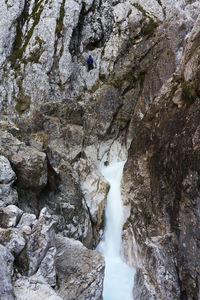 Low angle view of waterfall on rocks