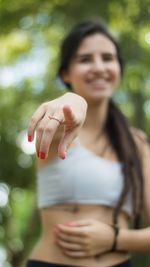 Close-up of young woman pointing