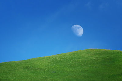 Scenic view of moon against clear blue sky