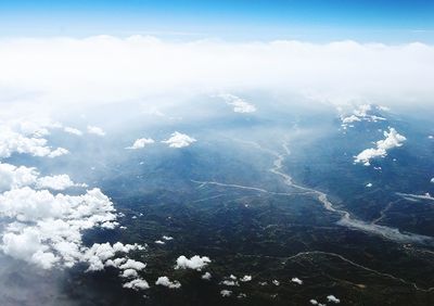 Scenic view of mountains against cloudy sky