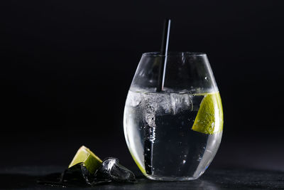 Close-up of drink in glass against black background