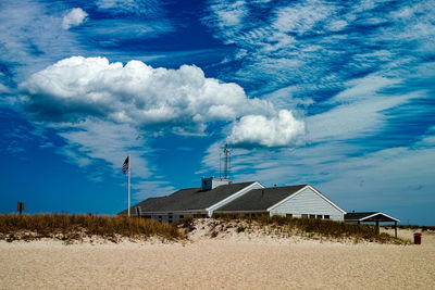 Houses against cloudy sky