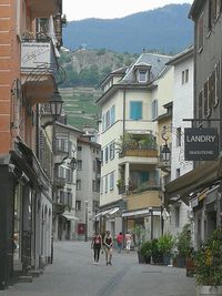 People walking on street amidst buildings in town