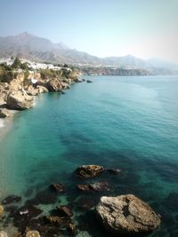 Scenic view of sea and mountains against sky