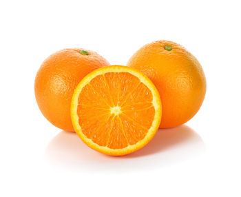 Close-up of orange slices over white background