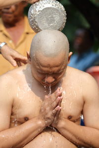 Midsection of shirtless man in water