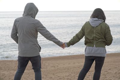 Rear view of couple on beach