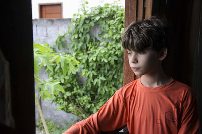 Boy looking through window