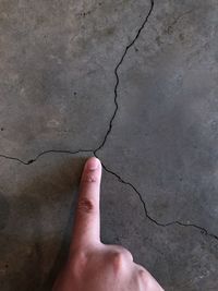 Midsection of person hand against wall