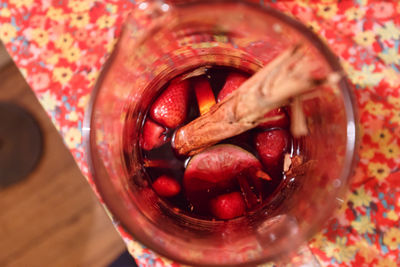 High angle view of cherries in glass jar on table