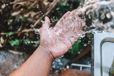 High angle view of hands splashing water