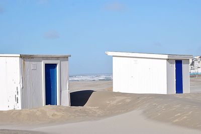 Built structure on beach against clear blue sky