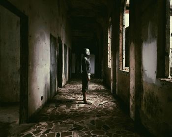 Man walking in corridor of building