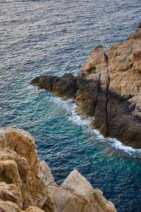 High angle view of rocks on sea shore