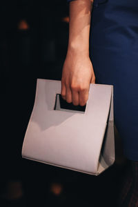 Cropped hand of woman holding paper